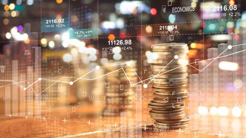 Double explosure with businesss charts of graph and rows of coins for finance at night city background. 
